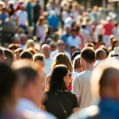 Crowd of people walking on the busy city street.