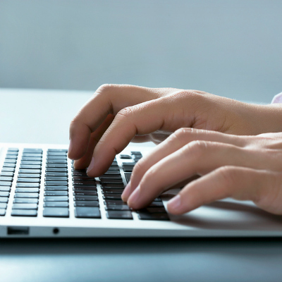 Closeup of businessman typing on laptop computer